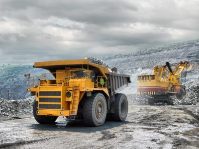 Loading of iron ore on very big dump-body truck