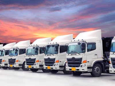 New truck fleet logistics transportation with beautiful sky sunset.